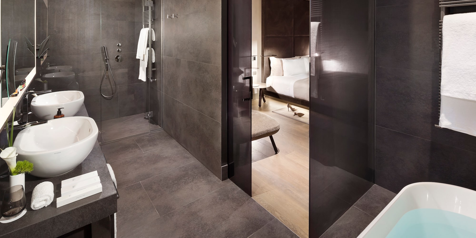 a bathroom with a shower and a bed