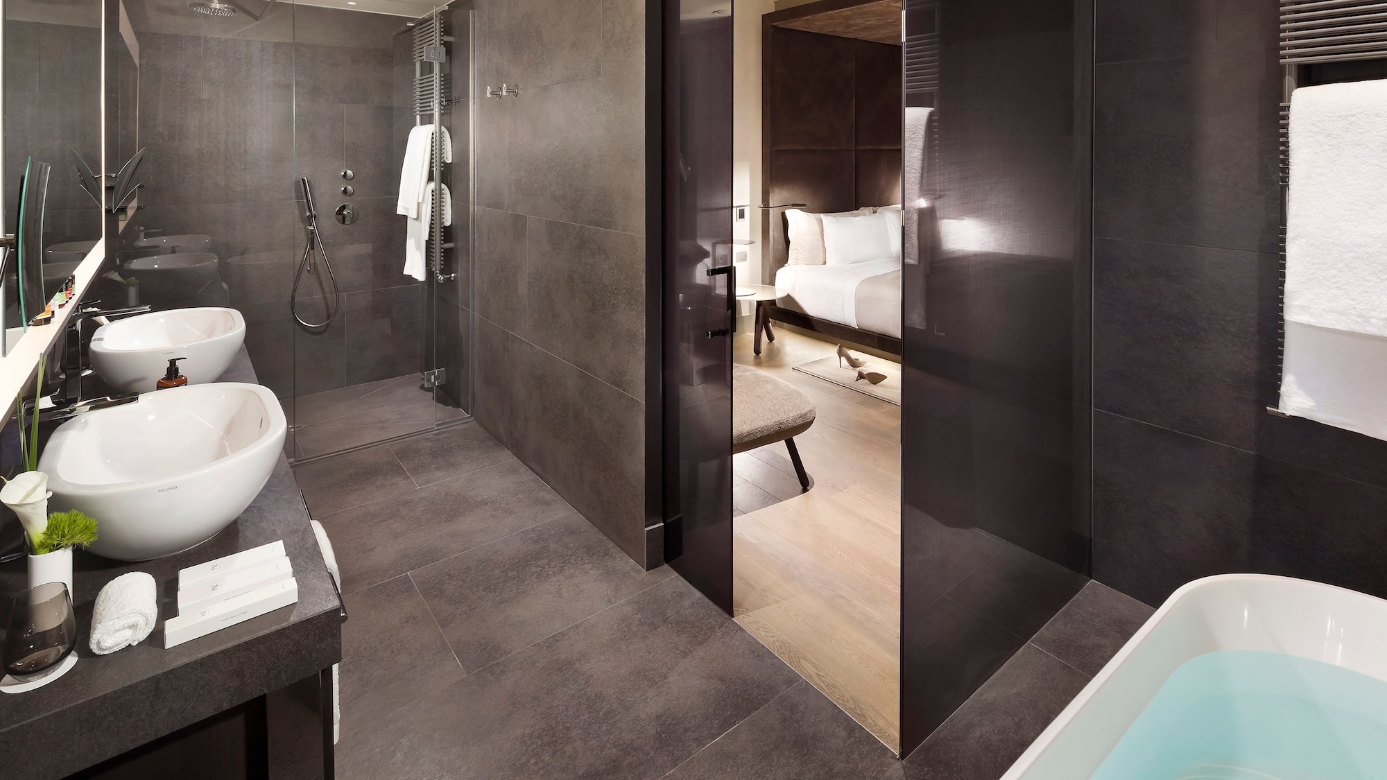a bathroom with a shower and a bed
