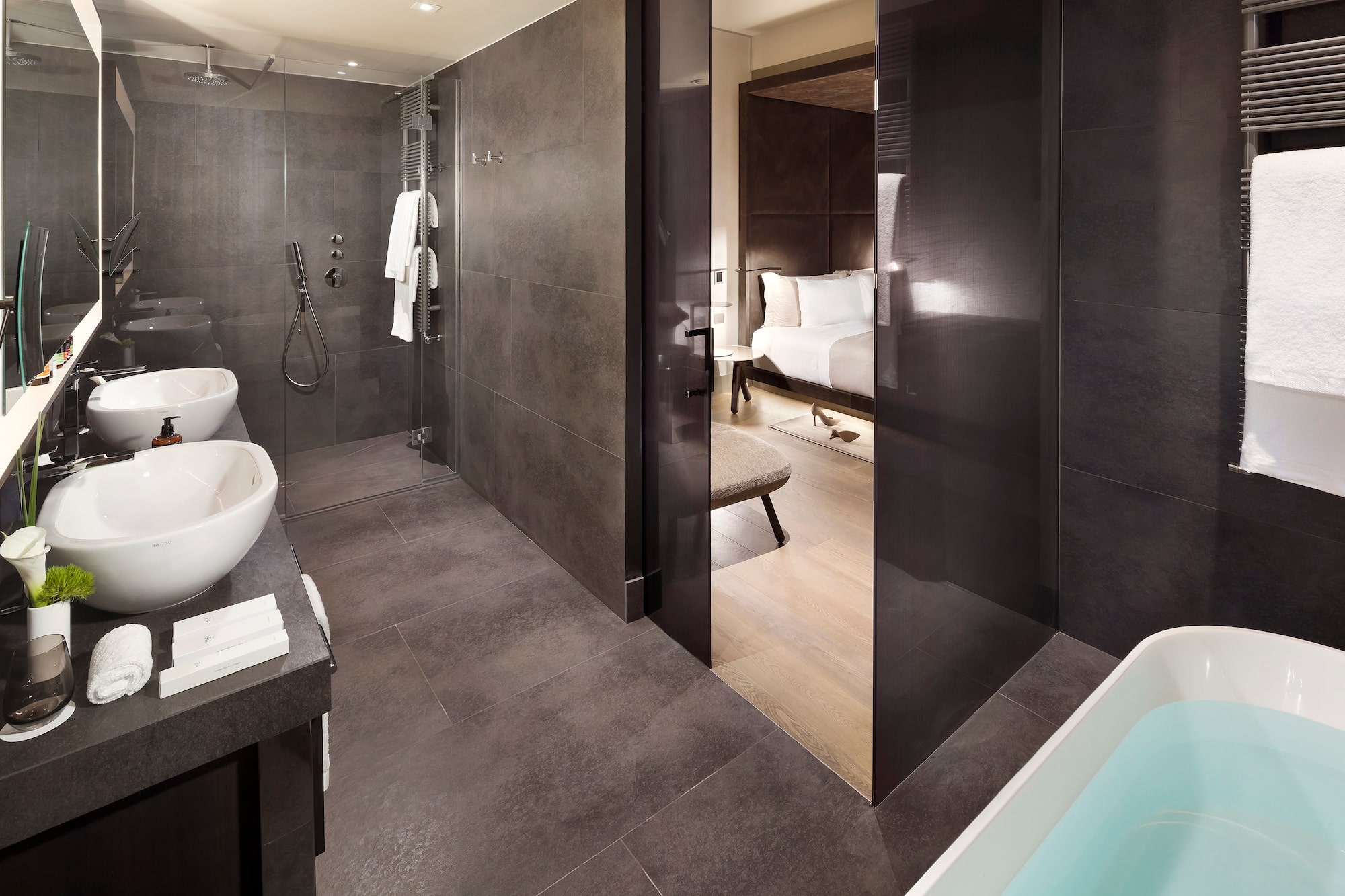 a bathroom with a shower and a bed