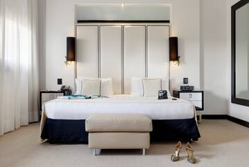 a bedroom with a bed and a pair of shoes
