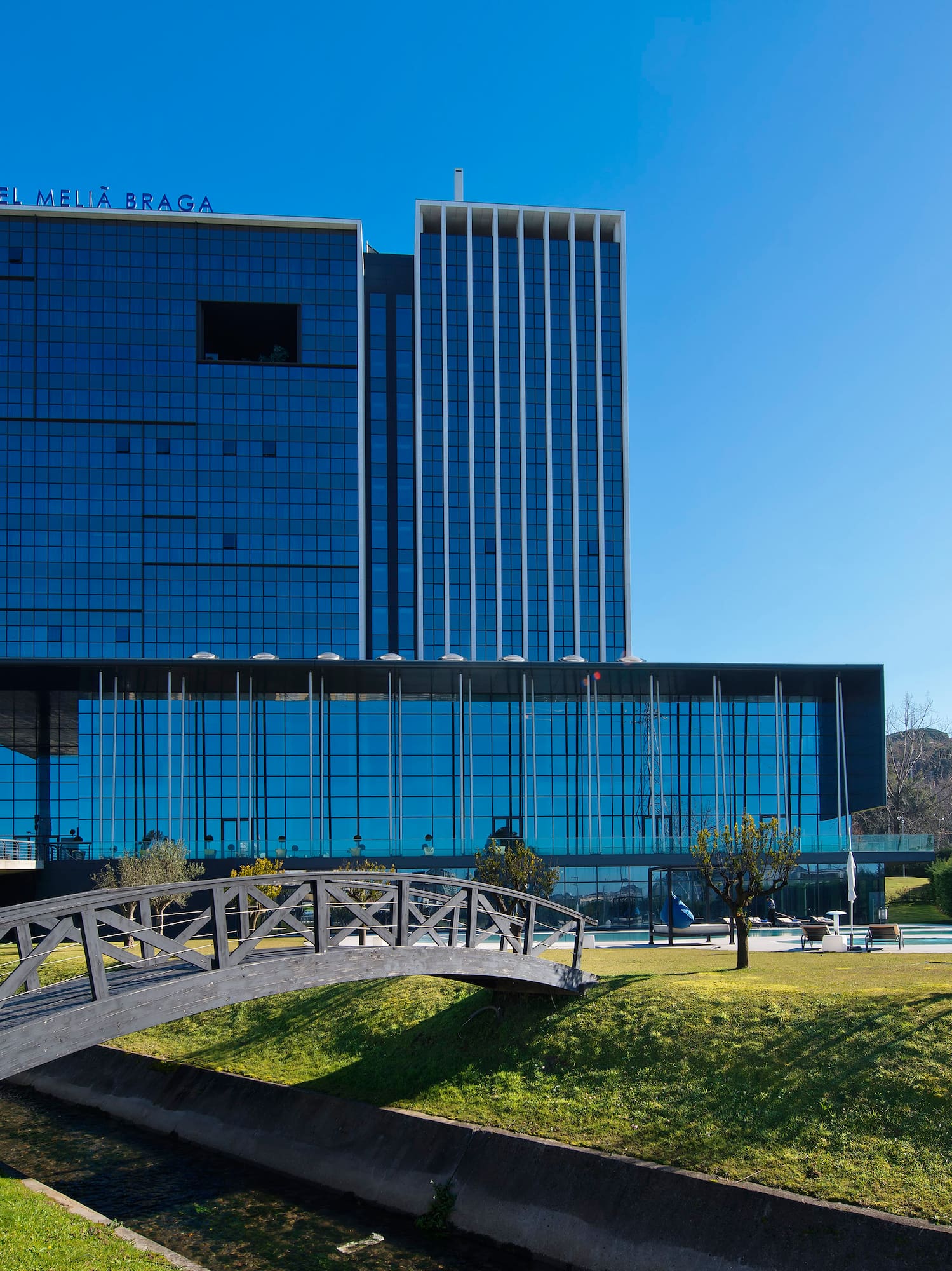 a bridge over a river with a building in the background