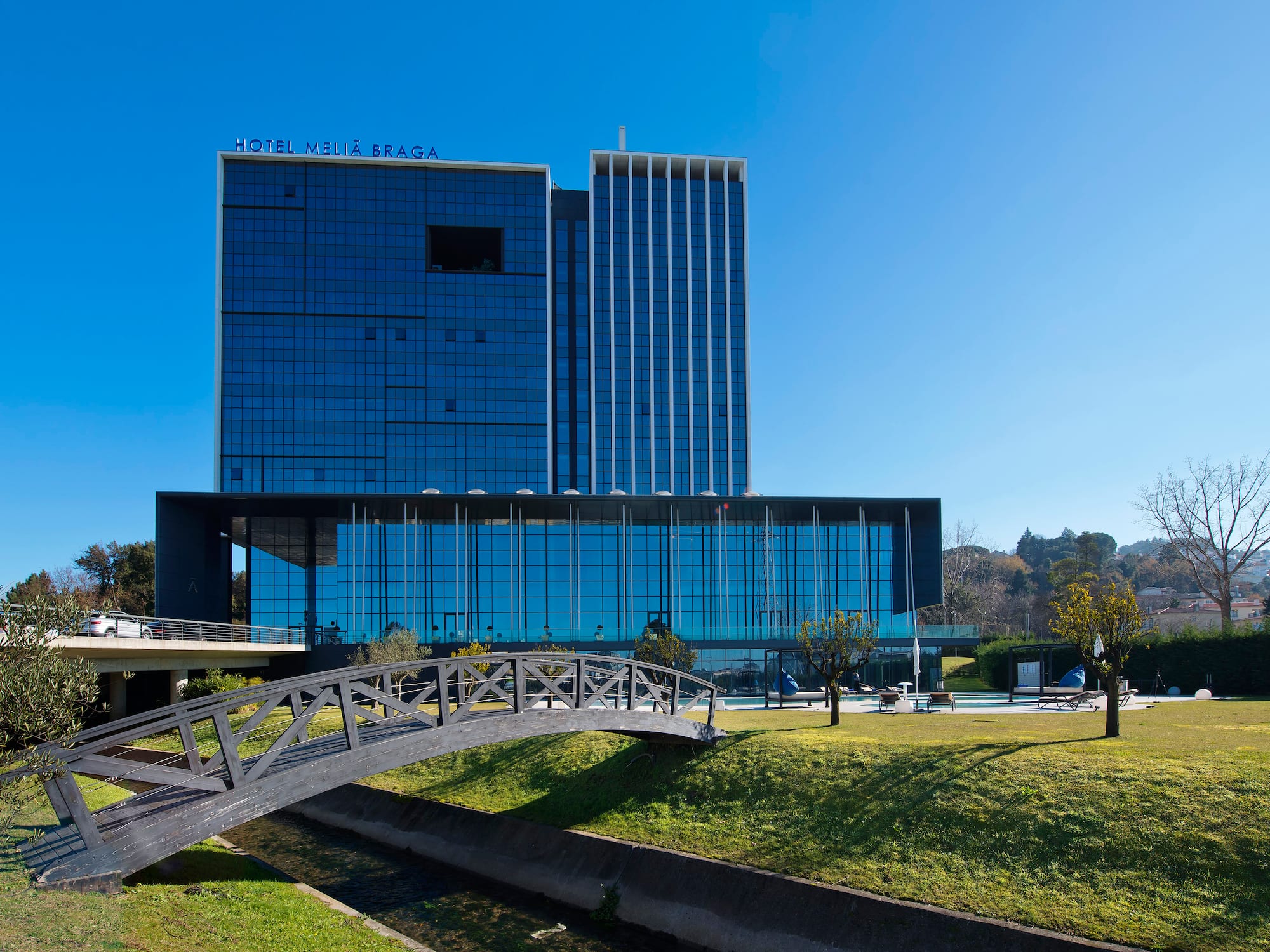 a bridge over a river with a building in the background