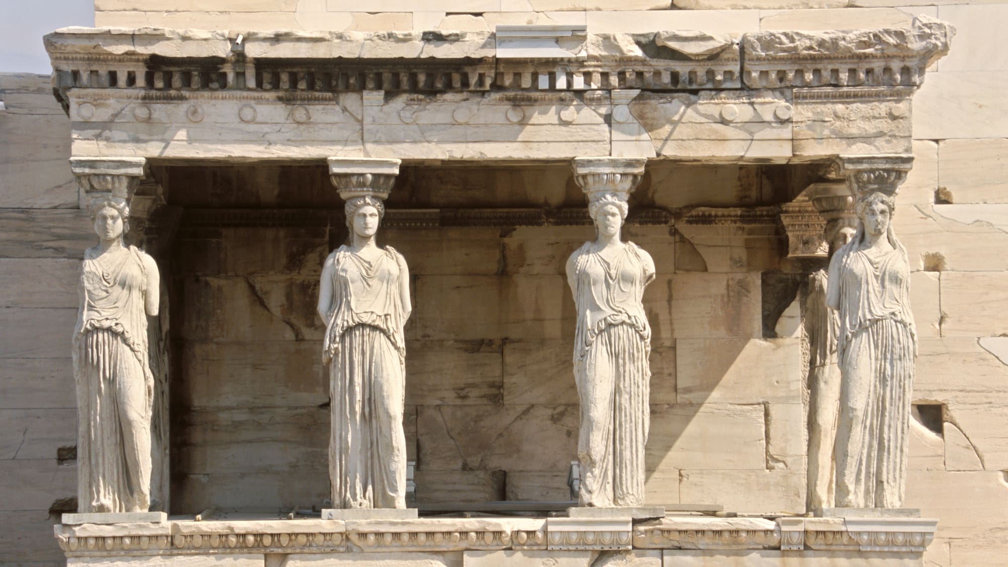 a group of statues on a stone building