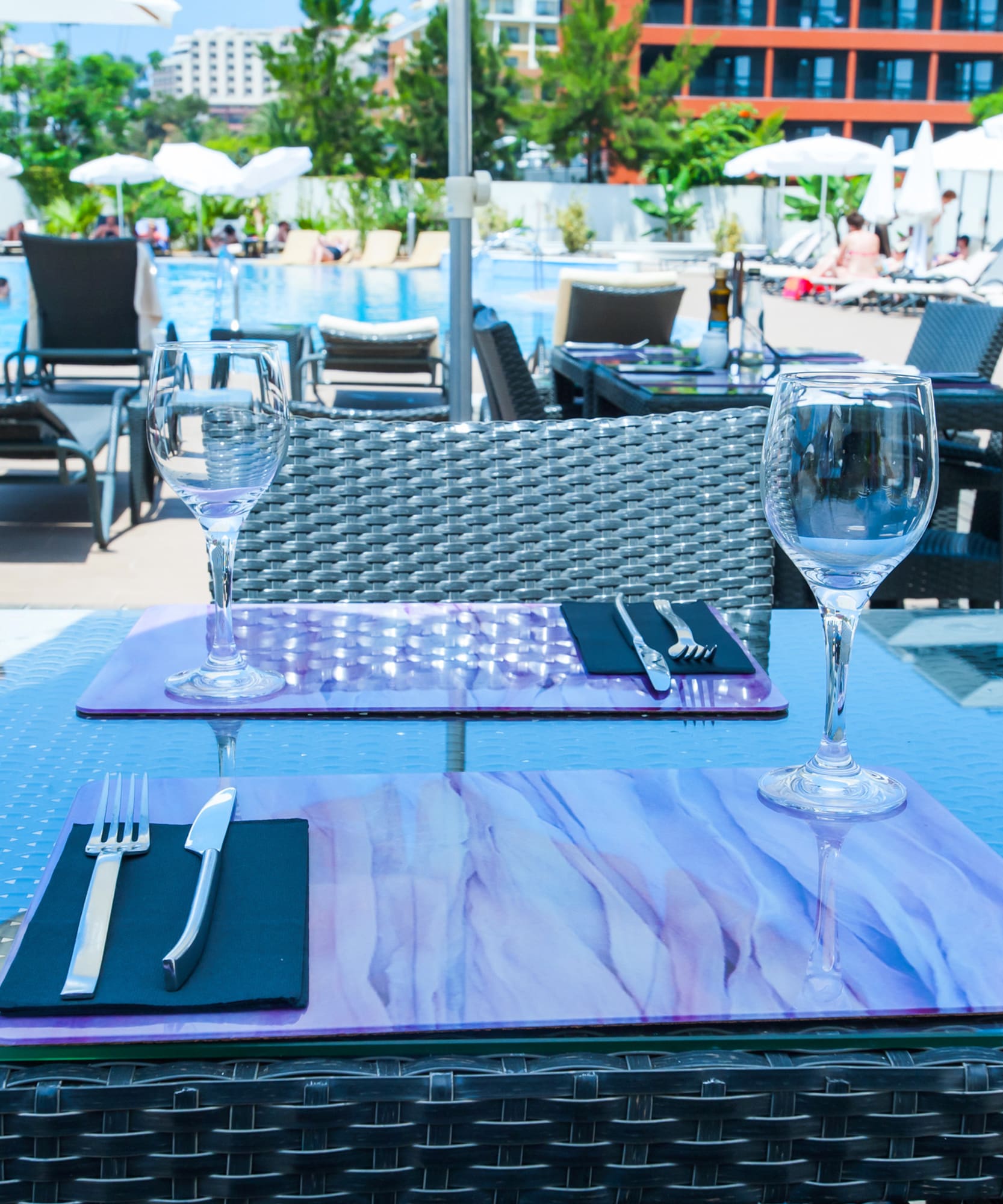a table with wine glasses and silverware on it