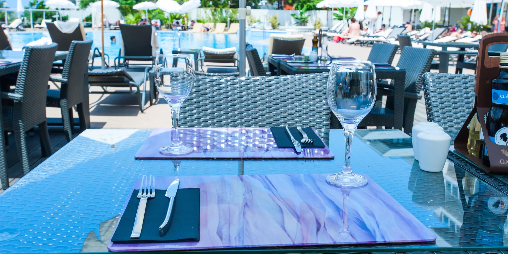 a table with wine glasses and silverware on it