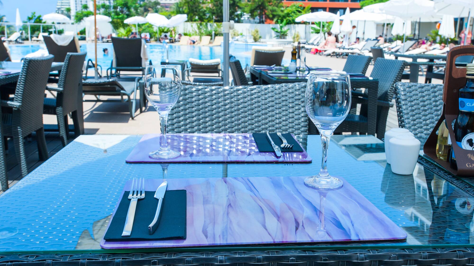 a table with wine glasses and silverware on it