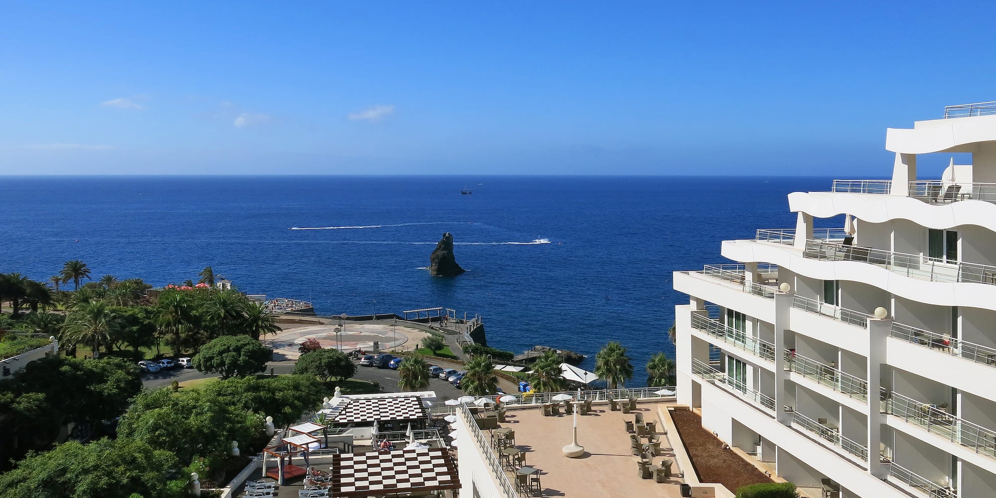a building with a body of water in the background