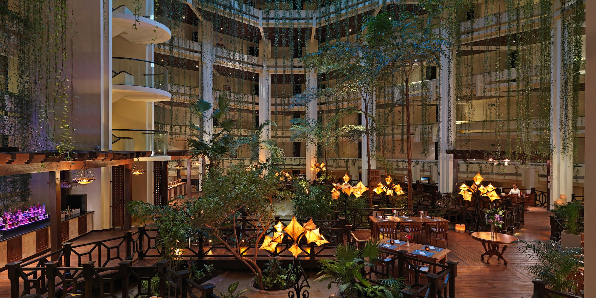 a room with tables and chairs and trees