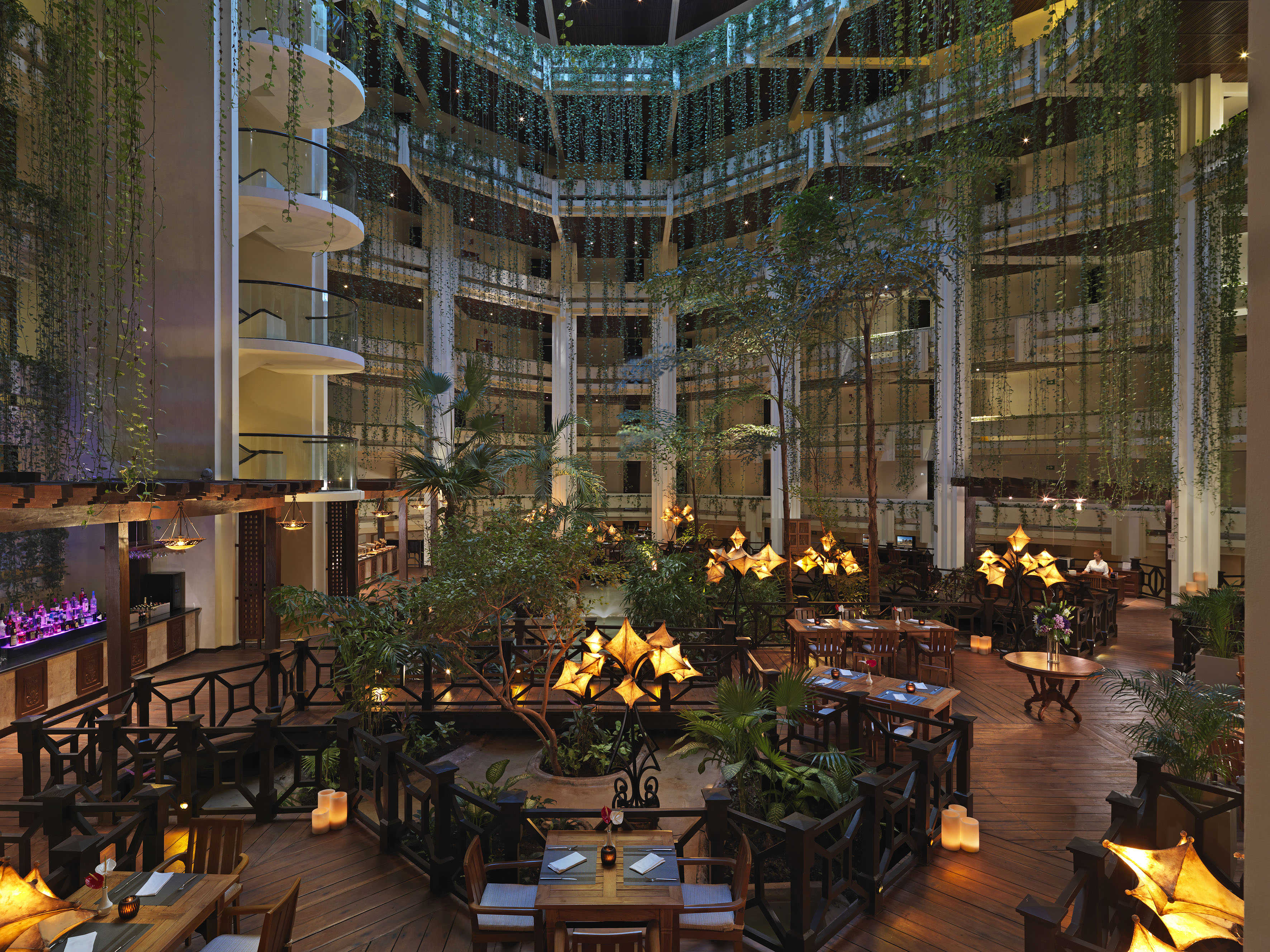 a room with tables and chairs and trees