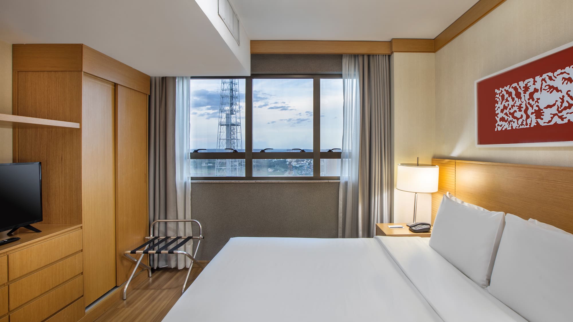 a hotel room with a large bed and a large window