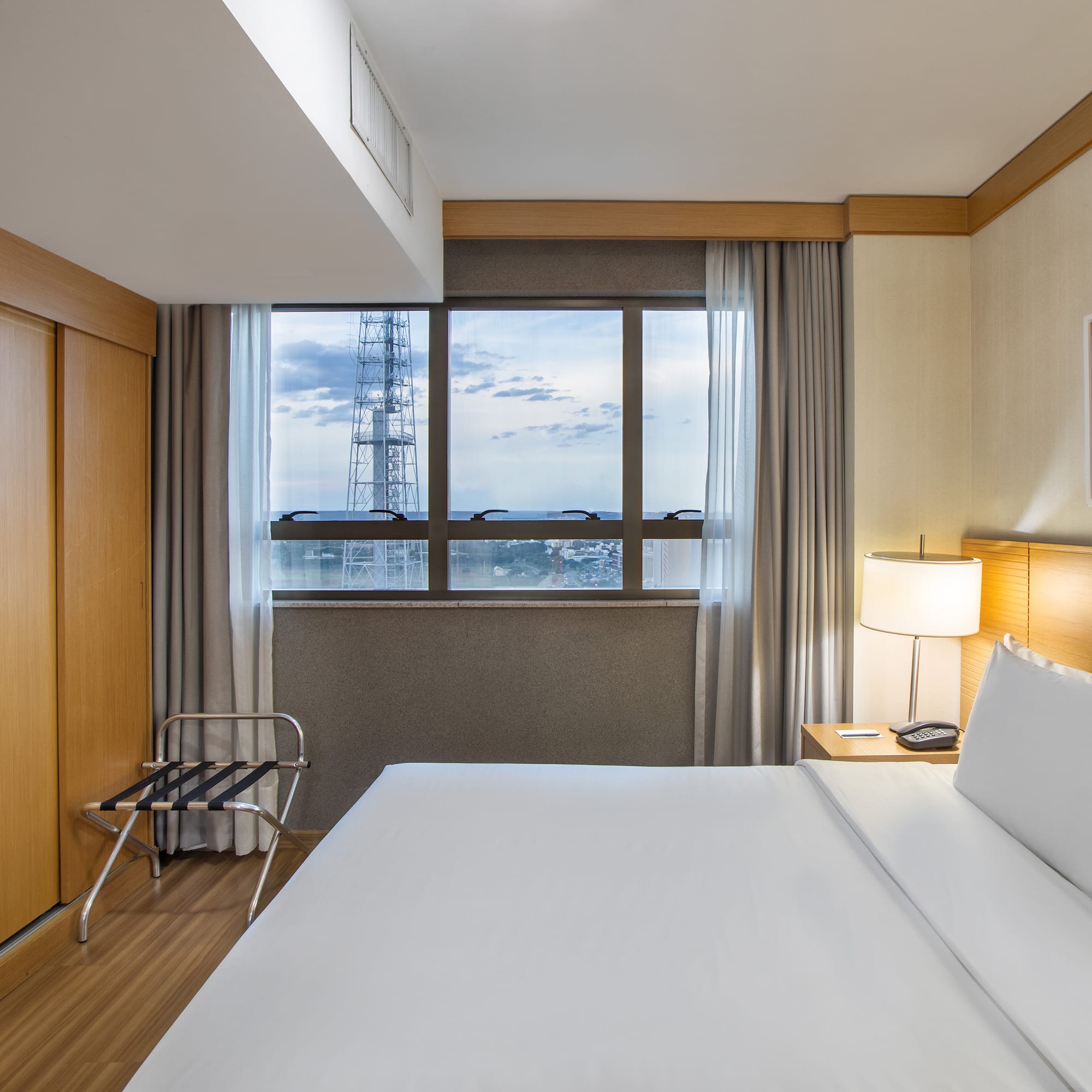 a hotel room with a large bed and a large window