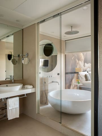 a bathroom with a large tub and a shower