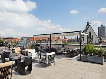 a rooftop patio with chairs and tables