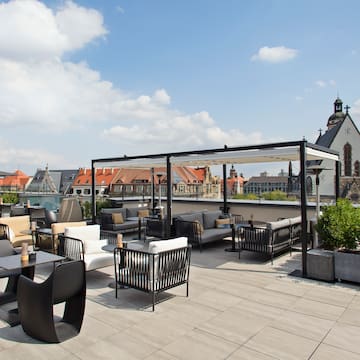 a rooftop patio with chairs and tables