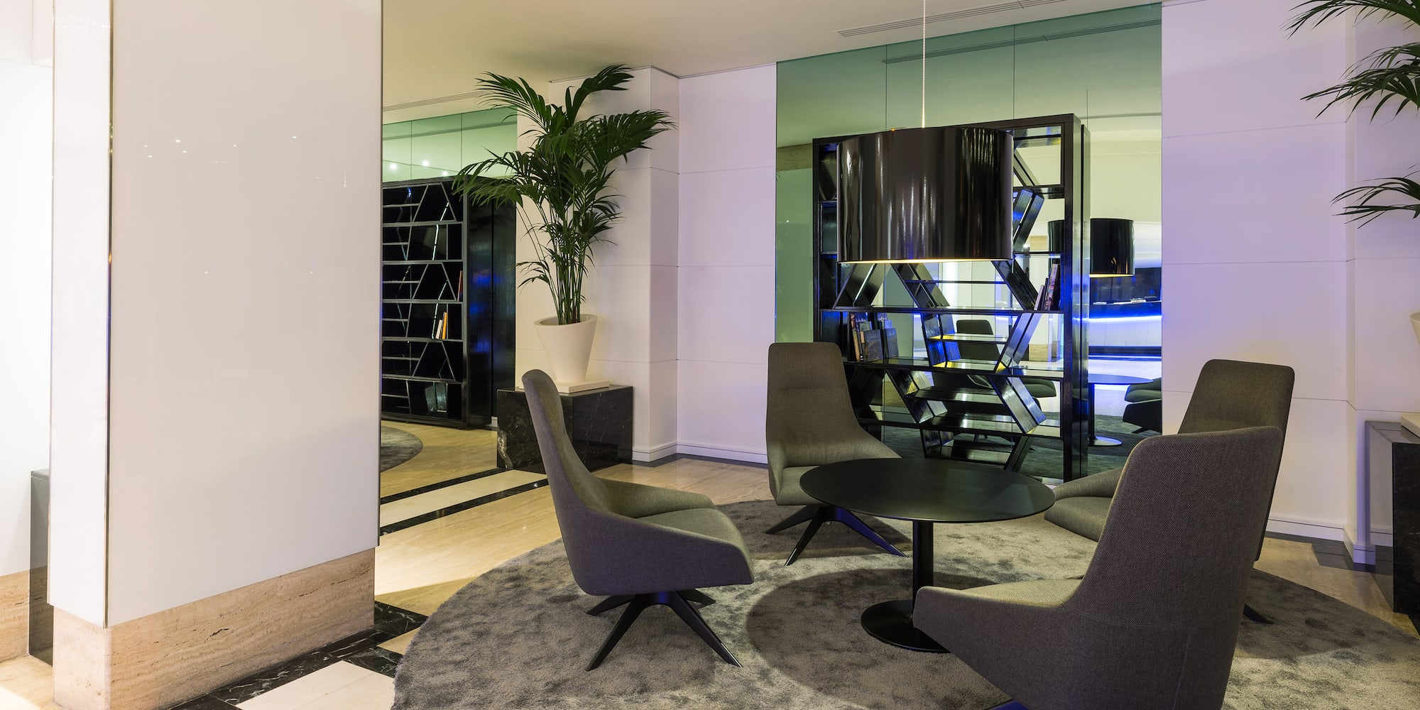 a room with a round table and chairs