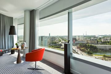 a room with a table and chairs and a window