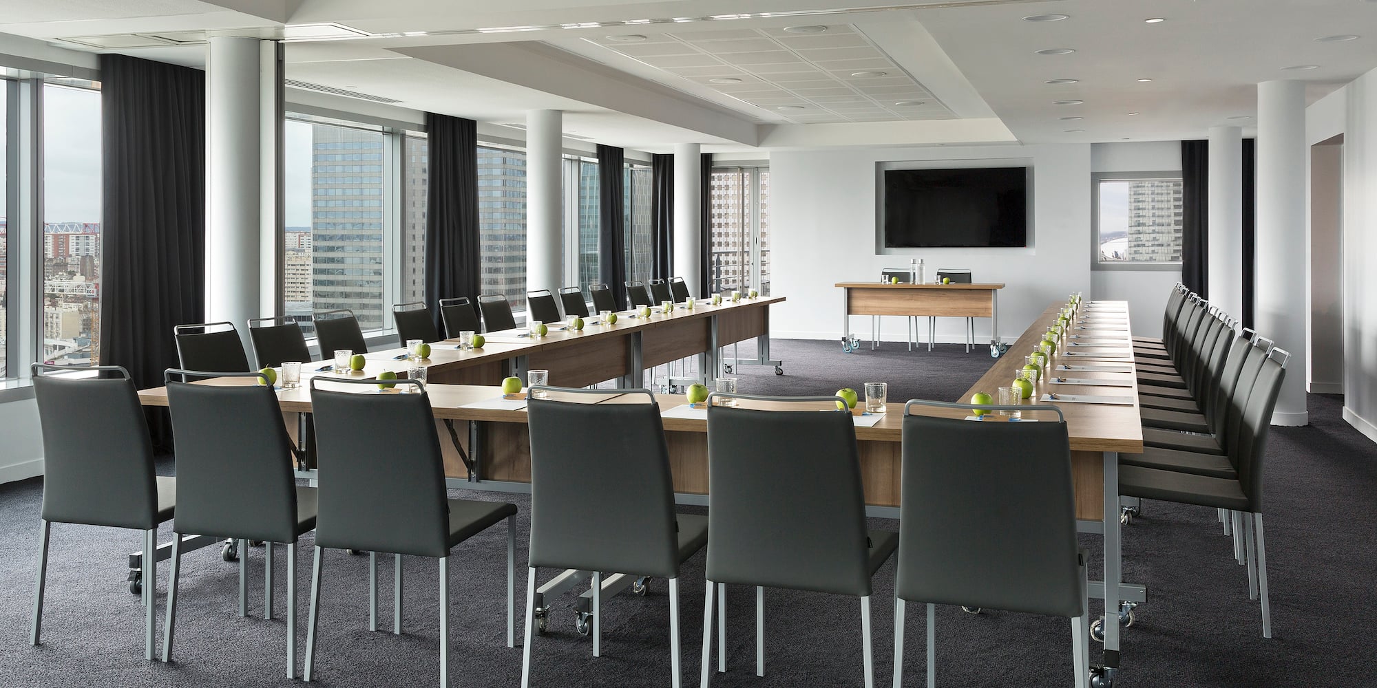 a room with long tables and chairs