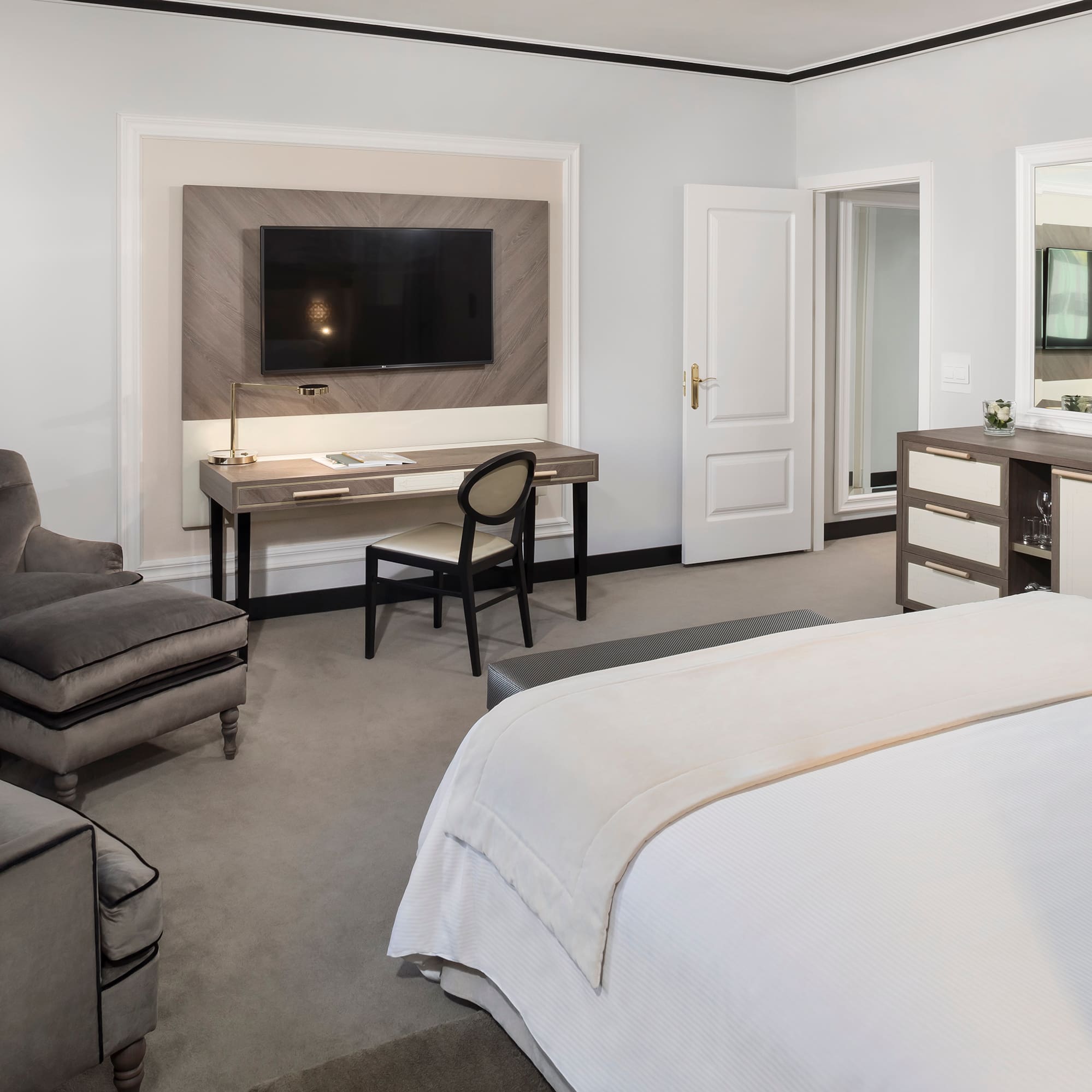 a bedroom with a tv and a bed