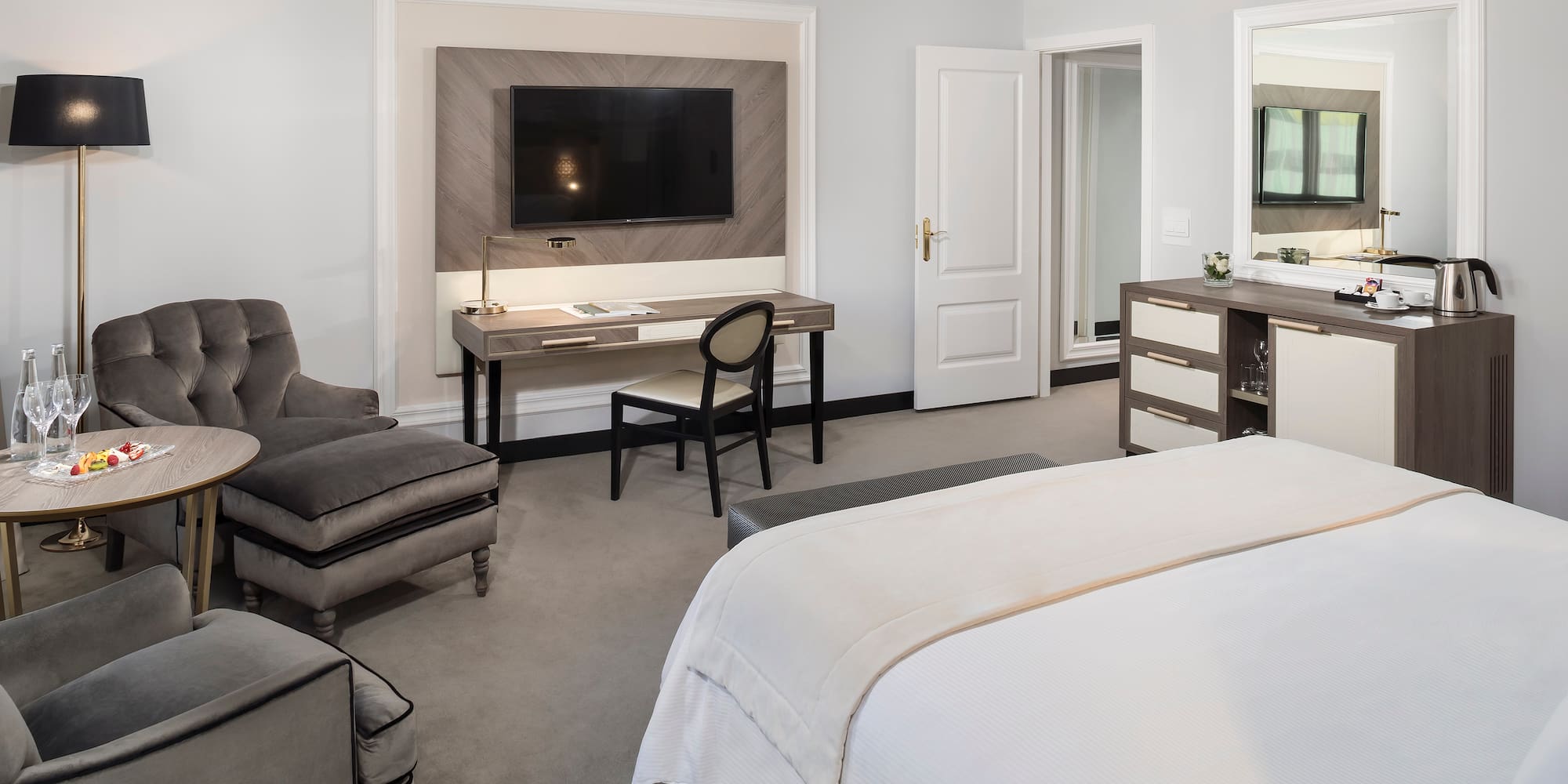 a bedroom with a tv and a bed