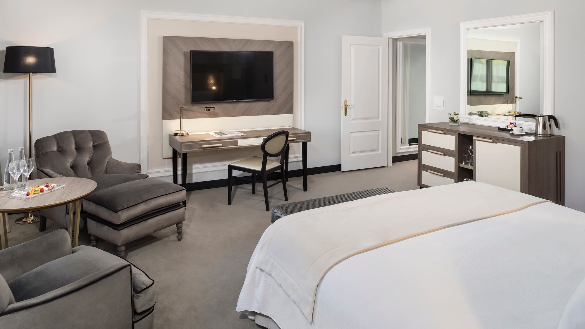 a bedroom with a tv and a bed