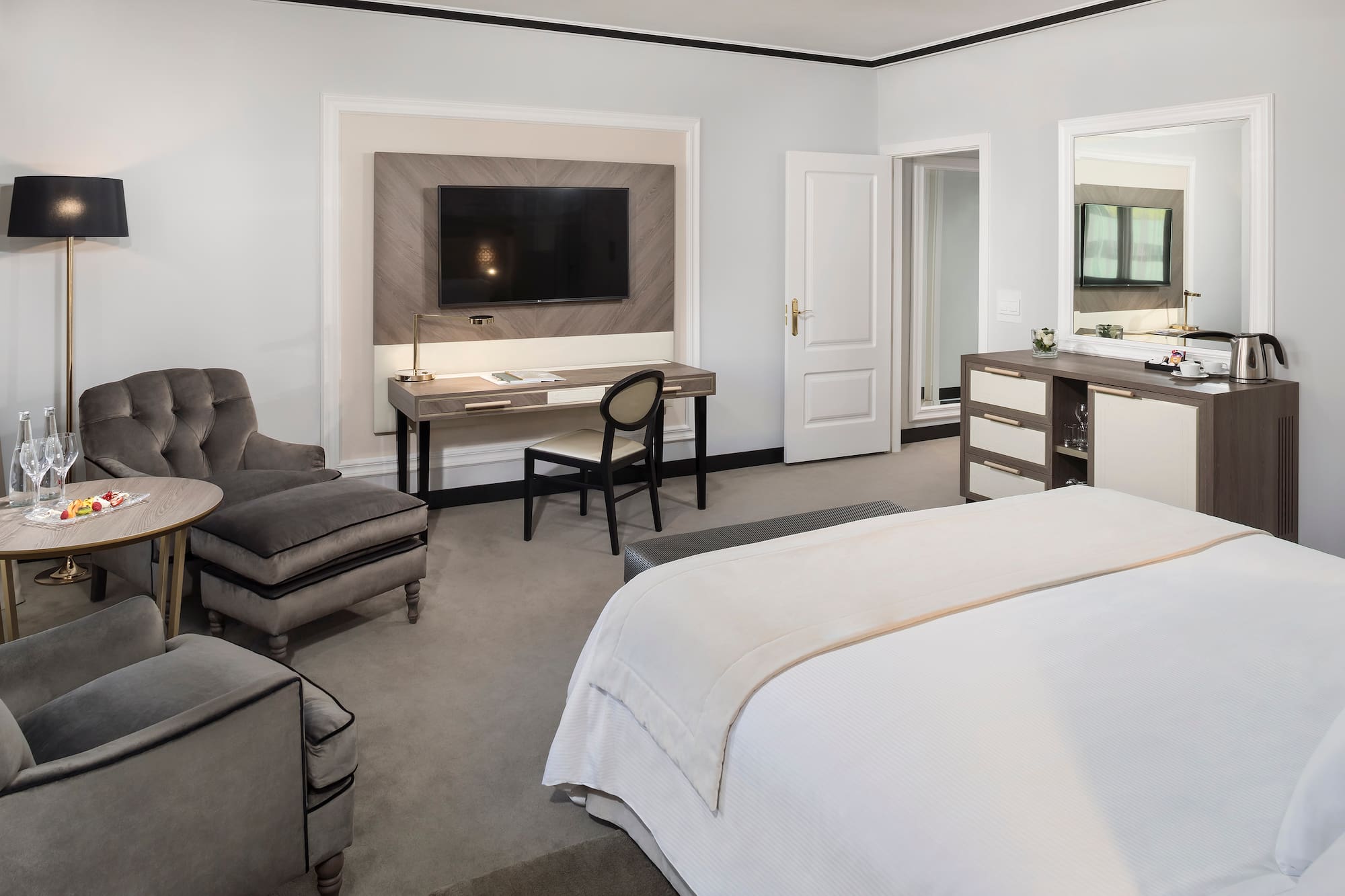 a bedroom with a tv and a bed