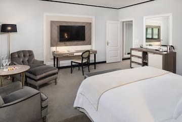 a bedroom with a tv and a bed