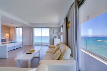 a living room with a view of the ocean