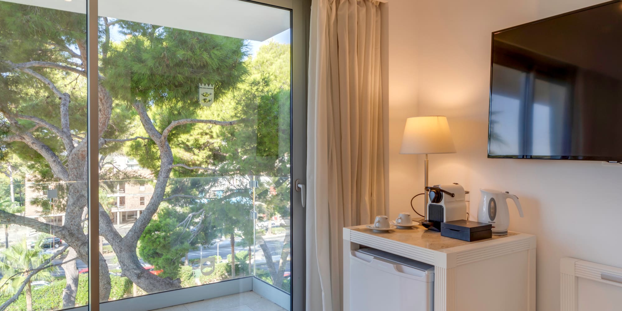 a room with a glass door and a television