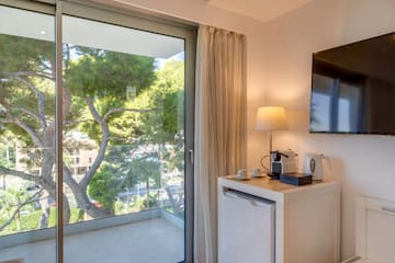 a room with a glass door and a television