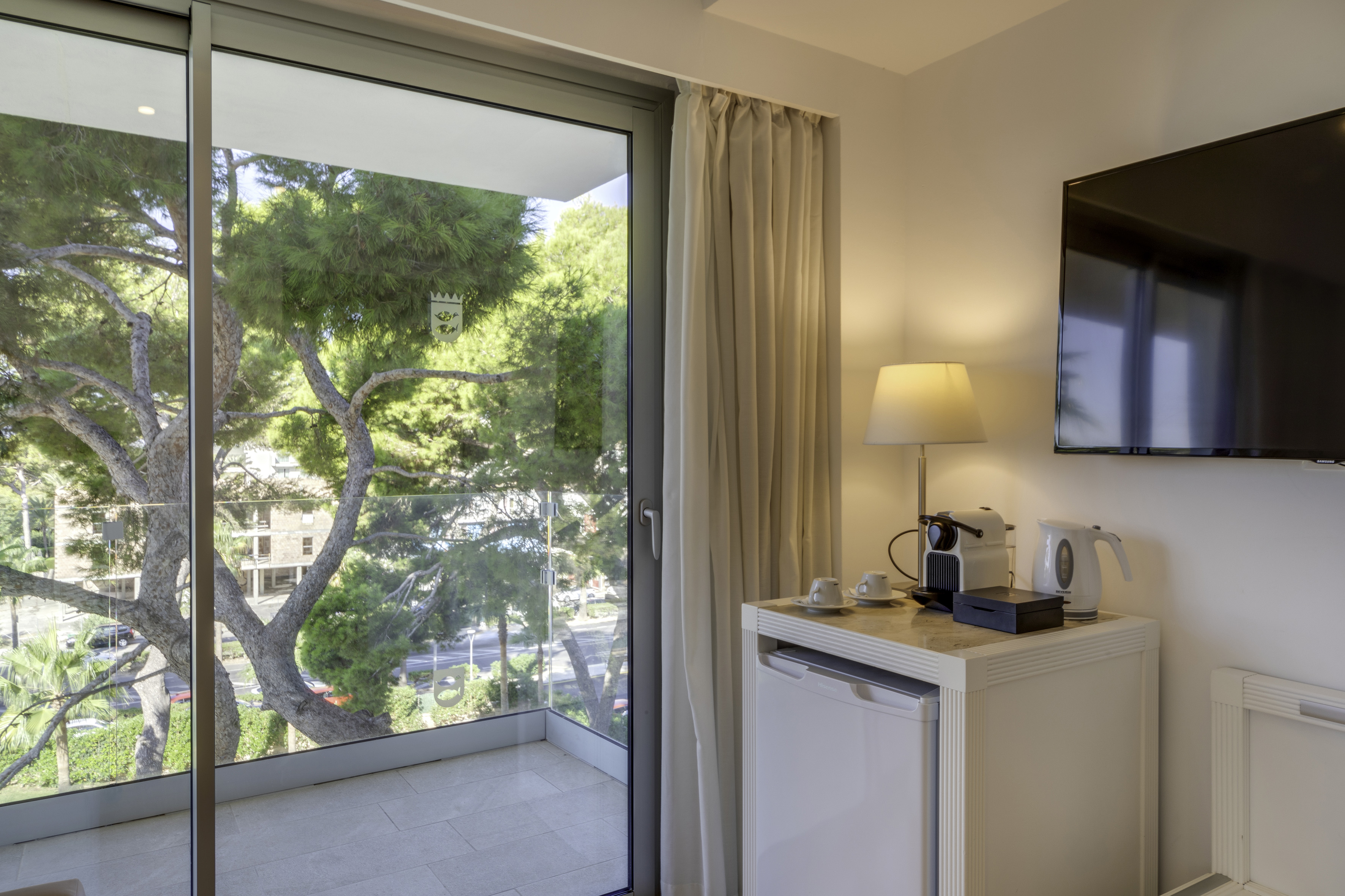 a room with a glass door and a television