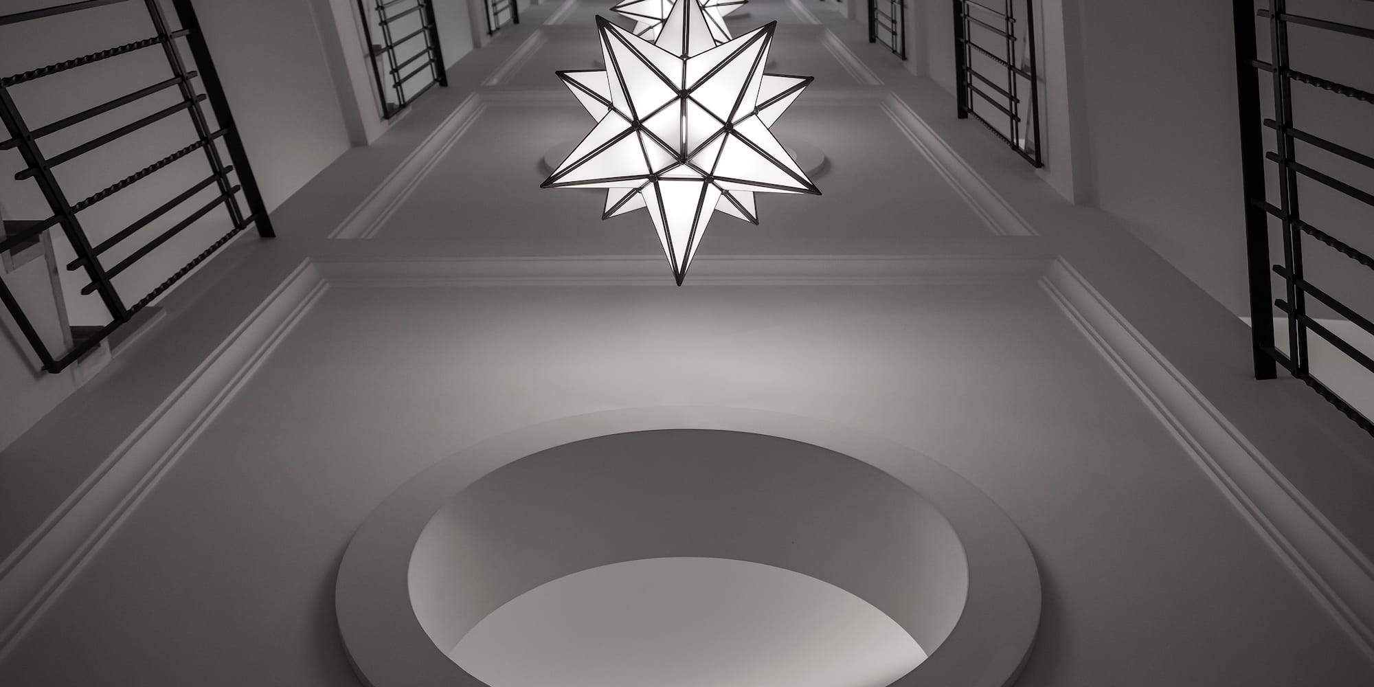 a star shaped light fixture from a ceiling