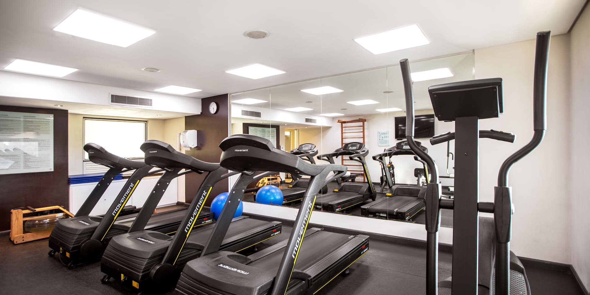 a room with treadmills and exercise equipment
