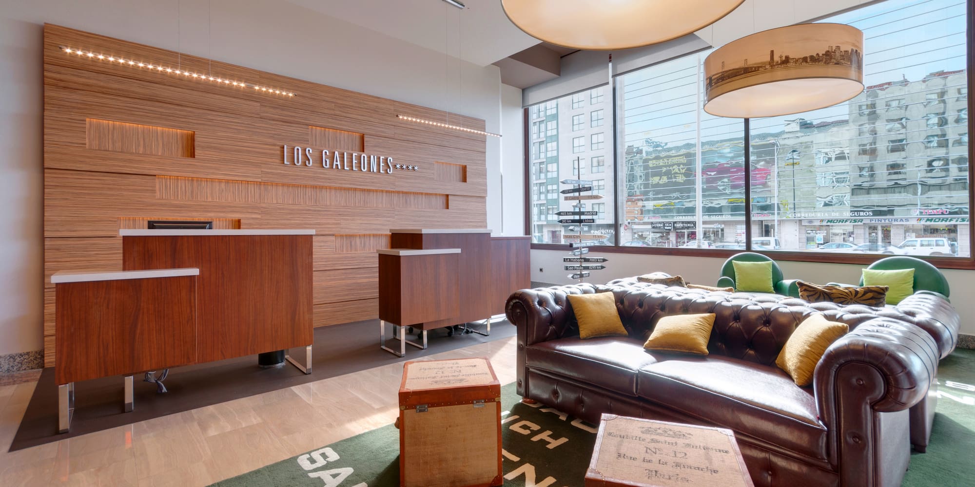 a reception area with a couch and stools