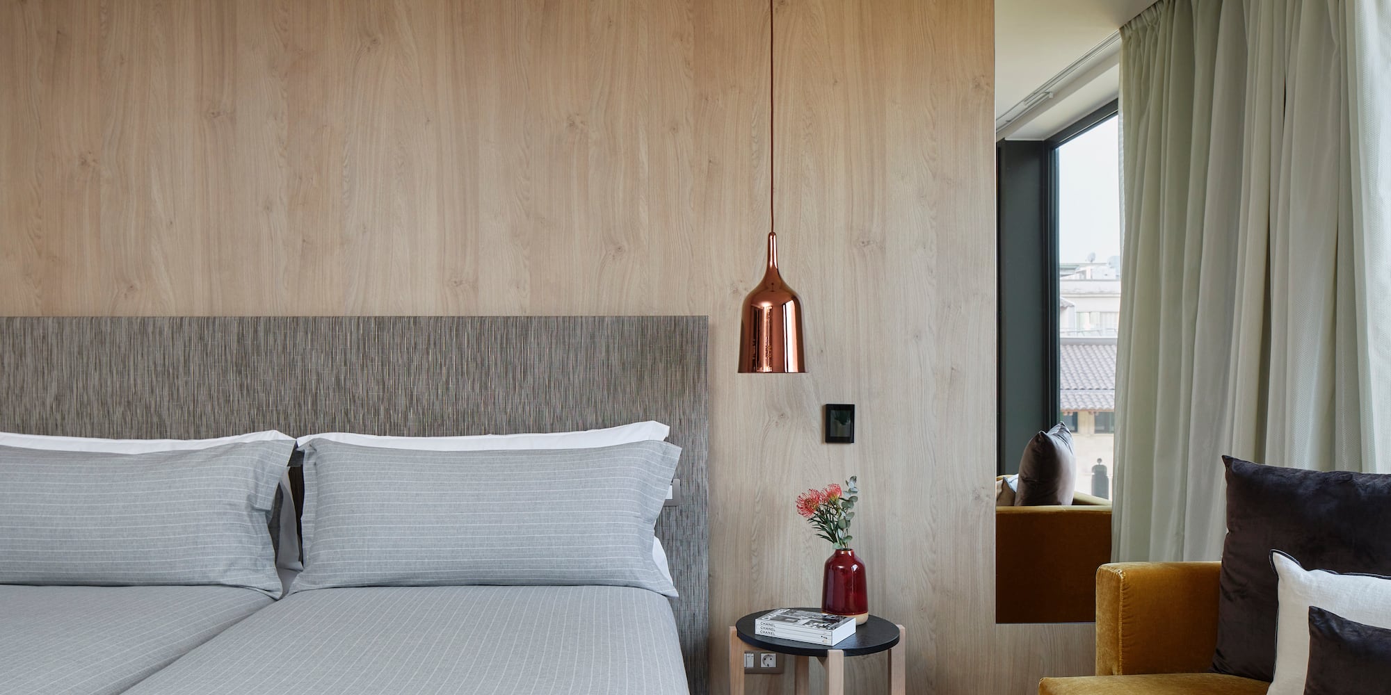 a bed with pillows and a lamp