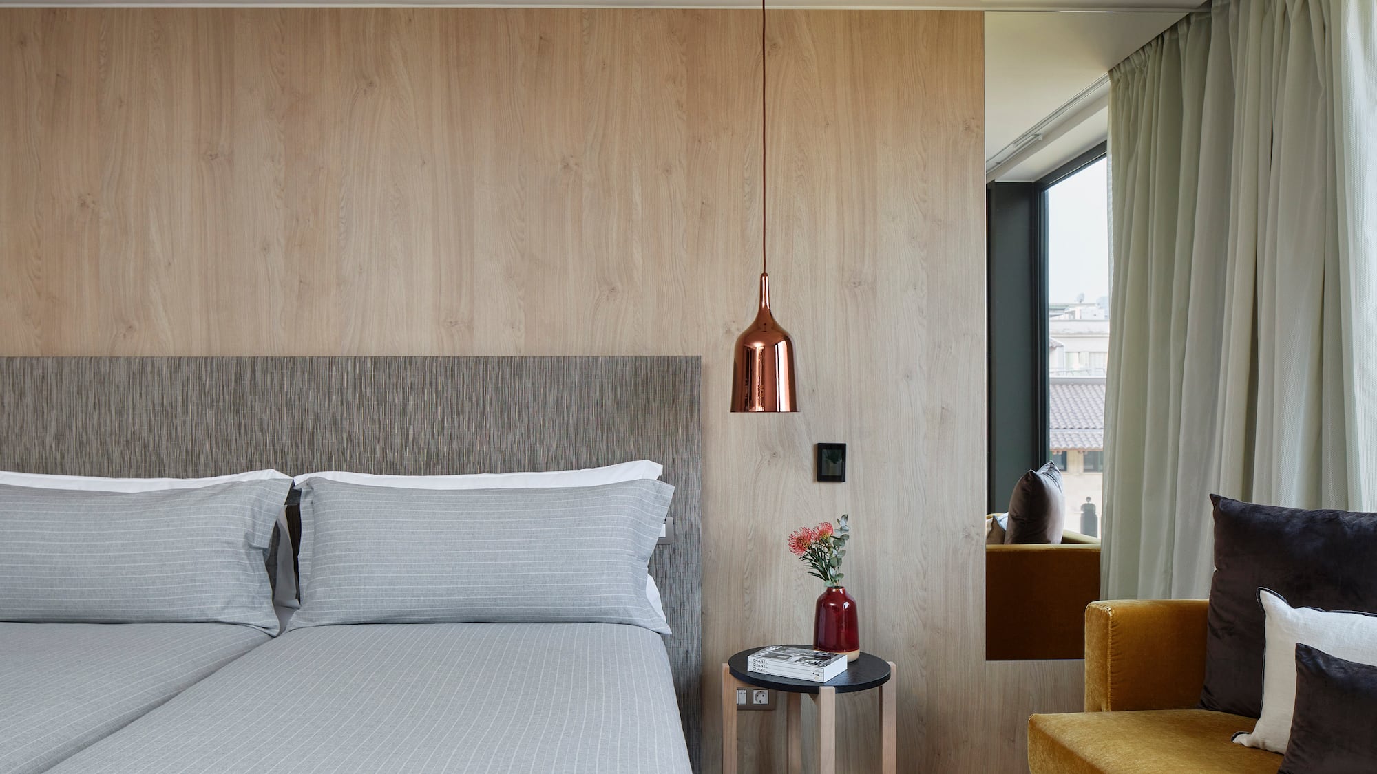 a bed with pillows and a lamp