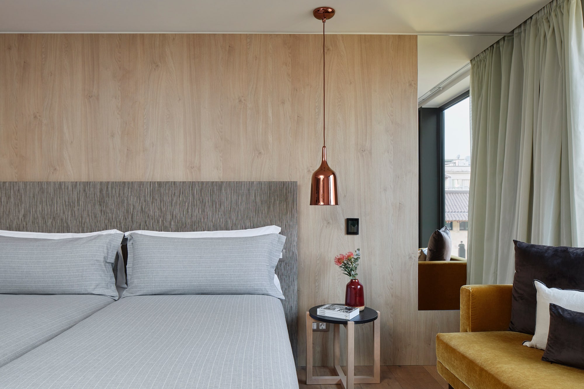 a bed with pillows and a lamp