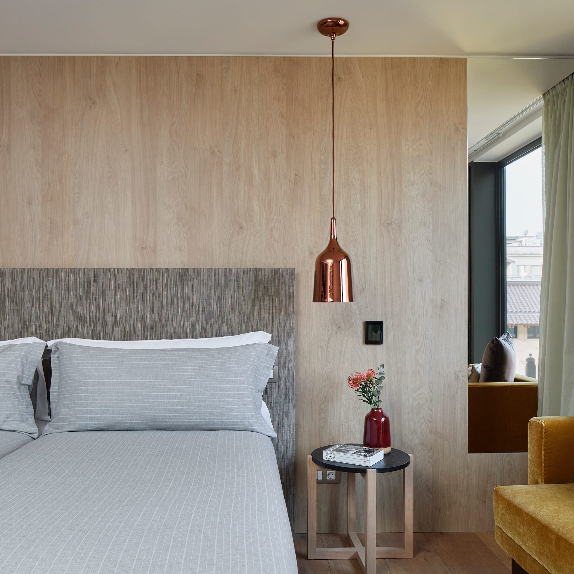 a bed with pillows and a lamp