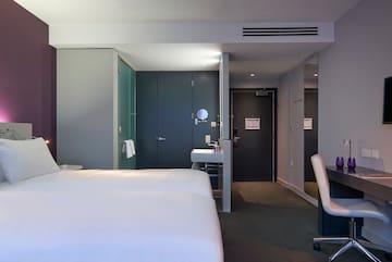 a room with two beds and a sink