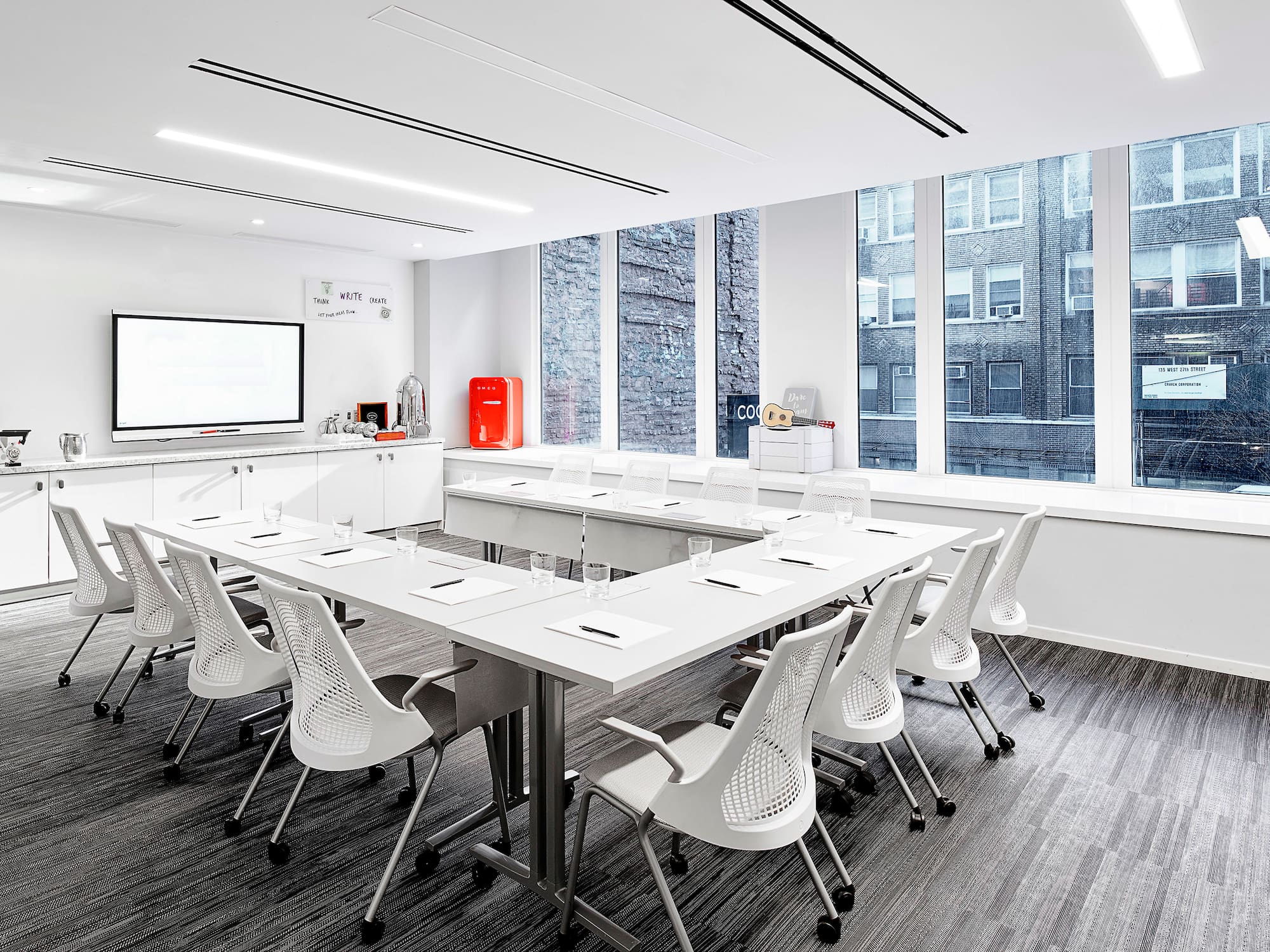 a room with white tables and chairs