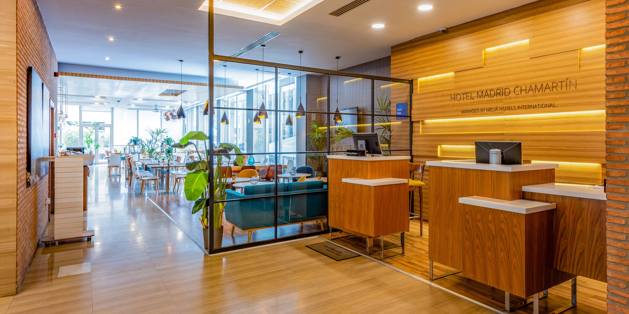 a lobby with a glass wall and a wood floor