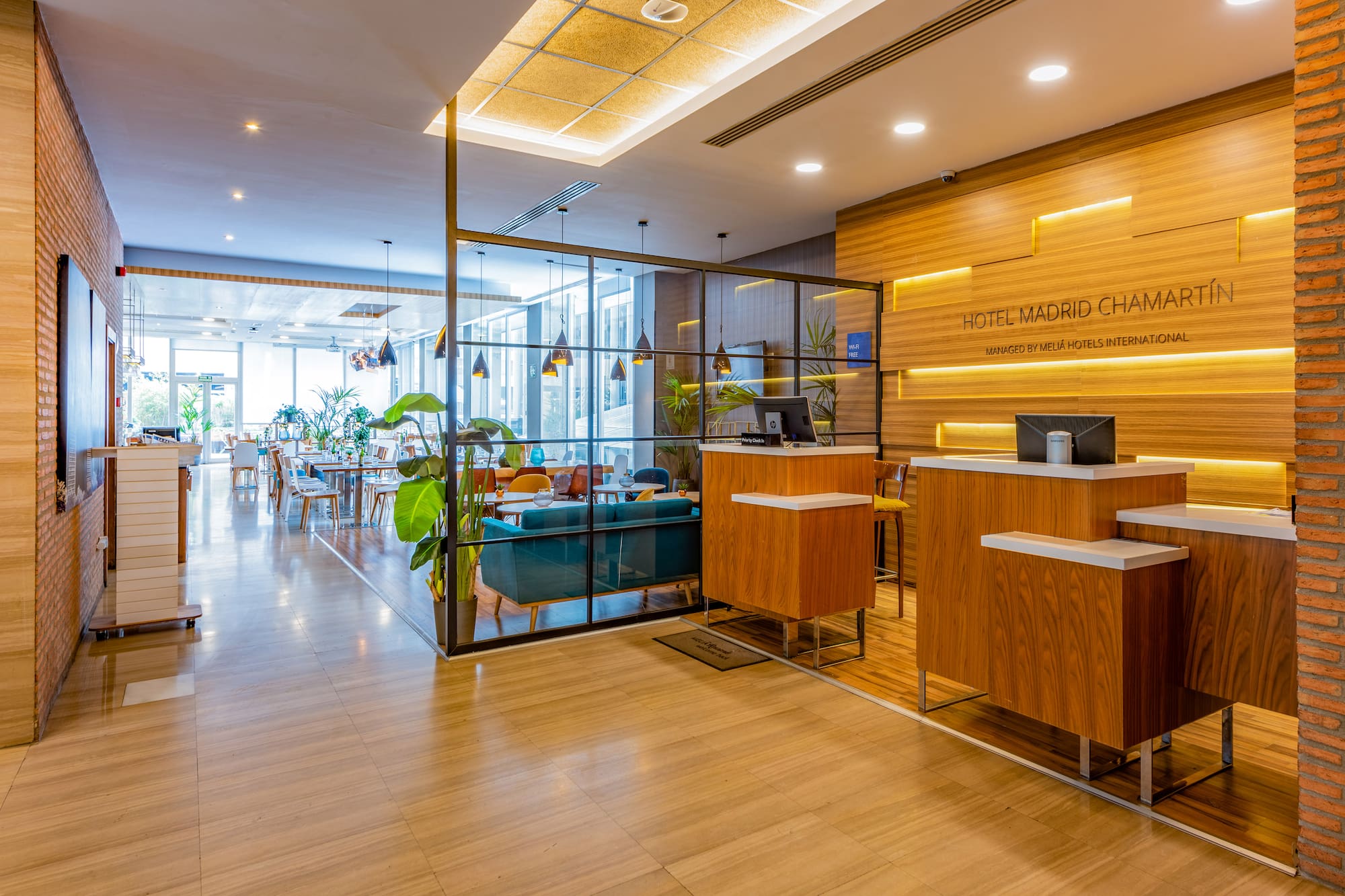 a lobby with a glass wall and a wood floor