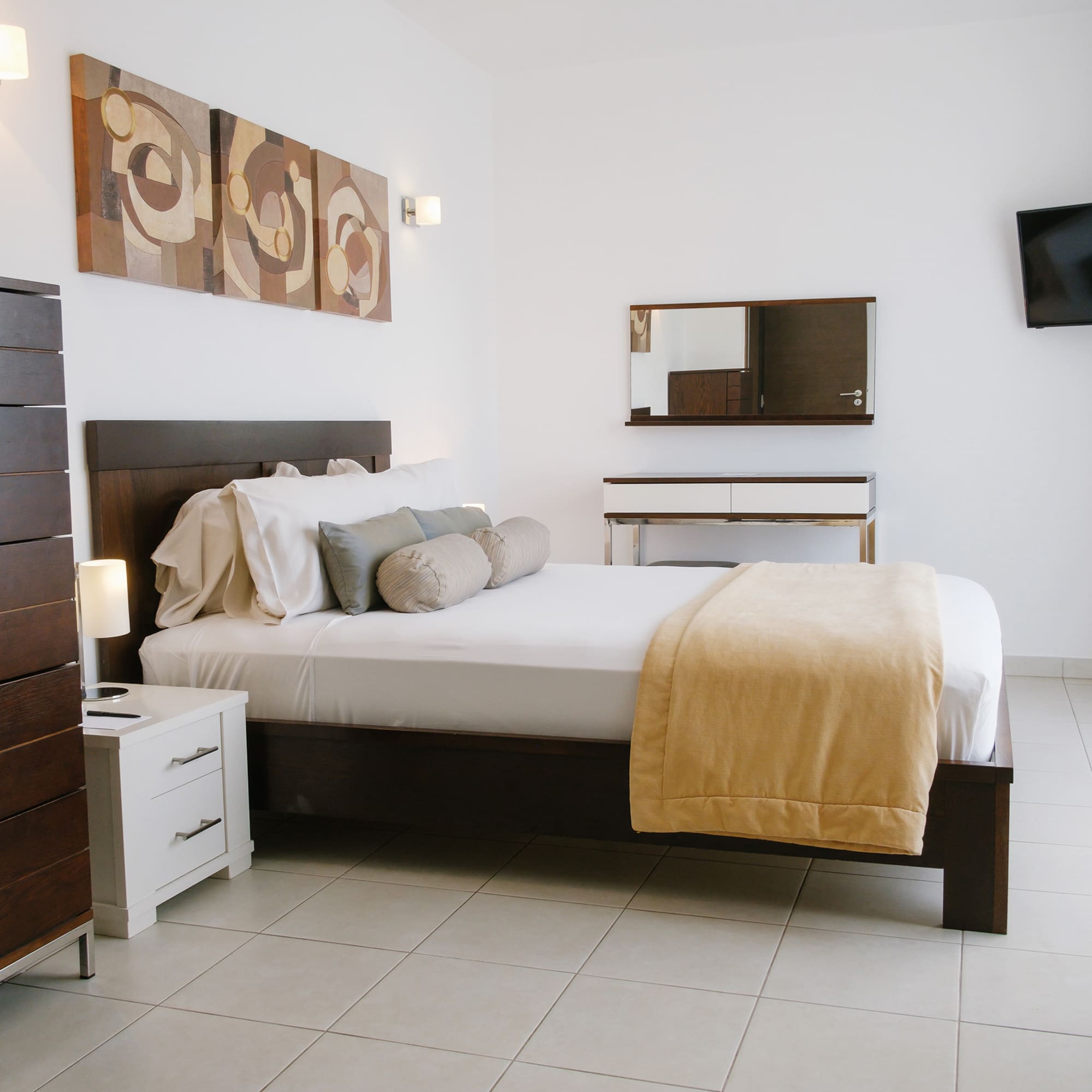 a bedroom with a bed and a television