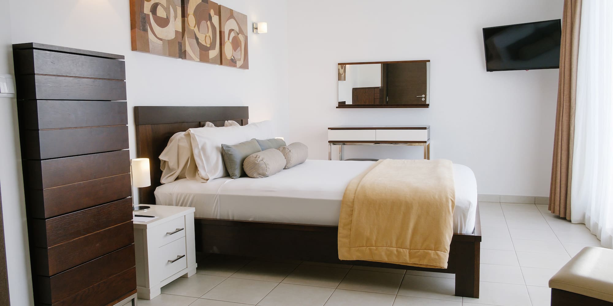 a bedroom with a bed and a television