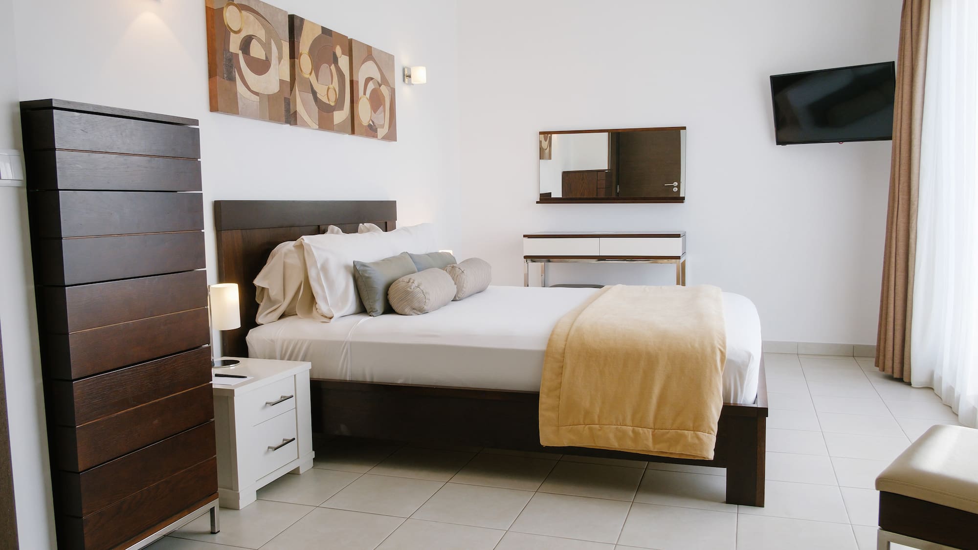 a bedroom with a bed and a television