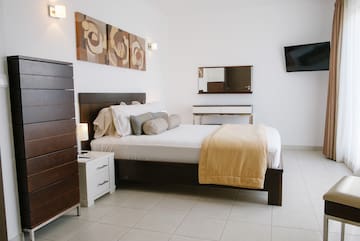 a bedroom with a bed and a television