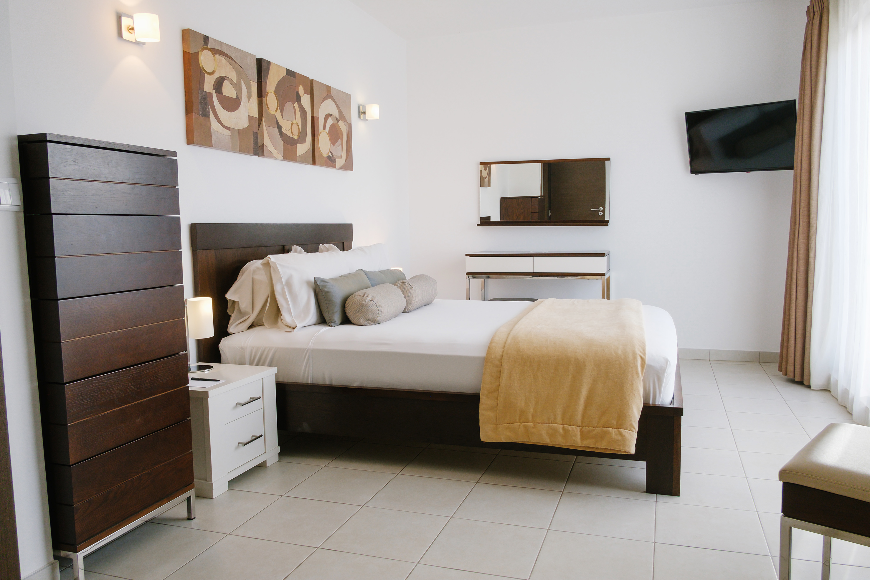 a bedroom with a bed and a television