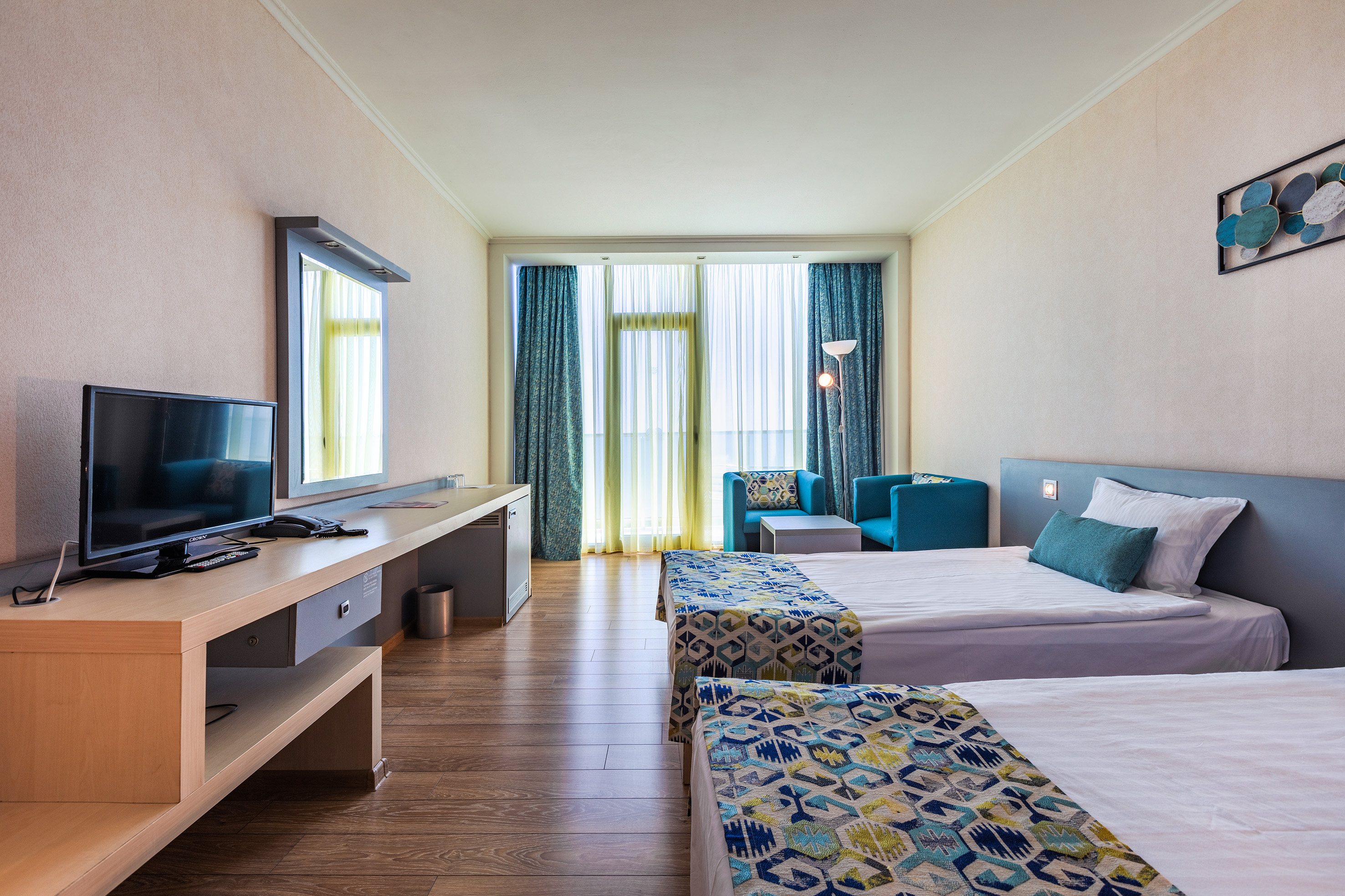 a room with two beds and a desk