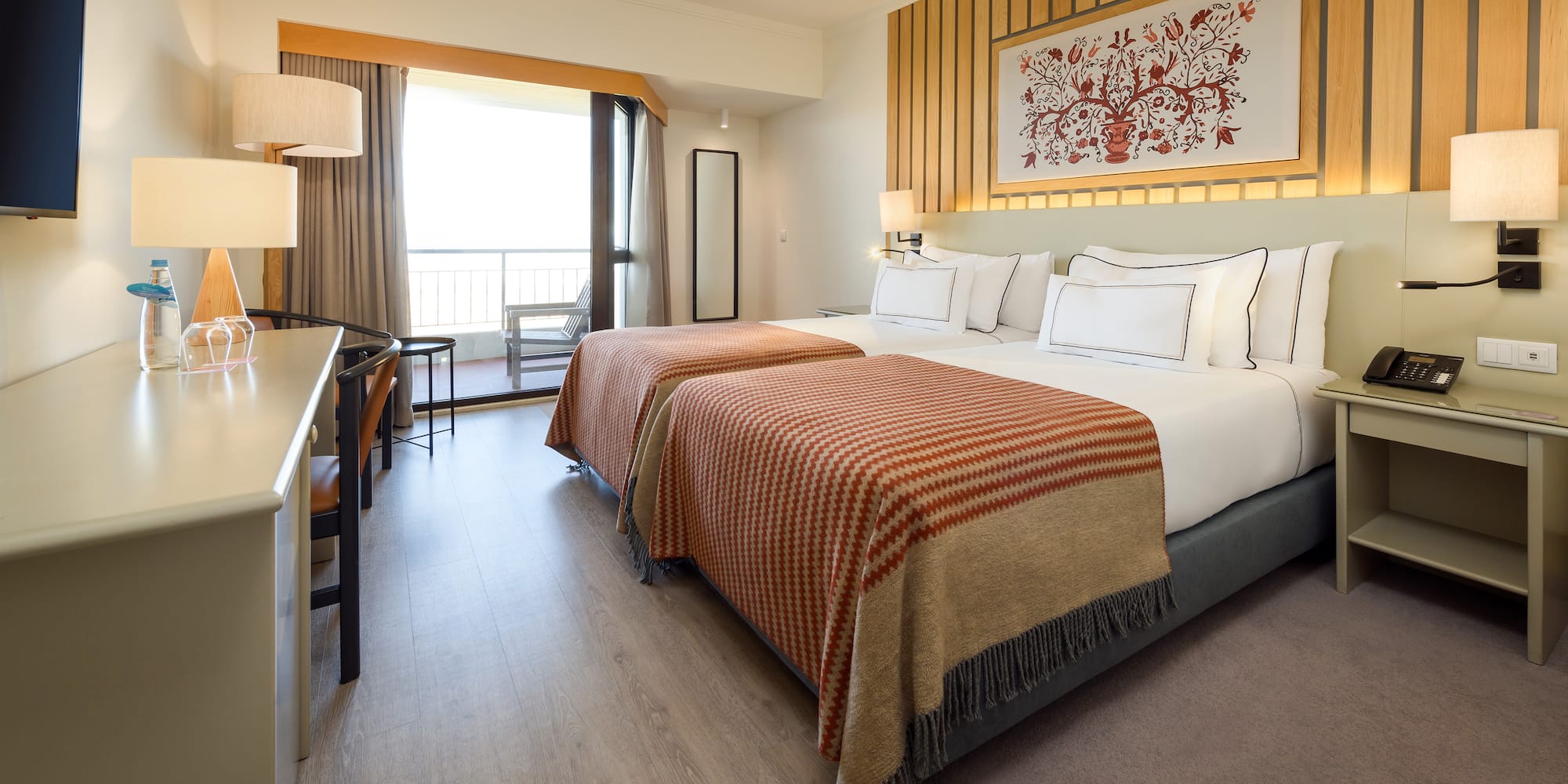 a room with two beds and a desk