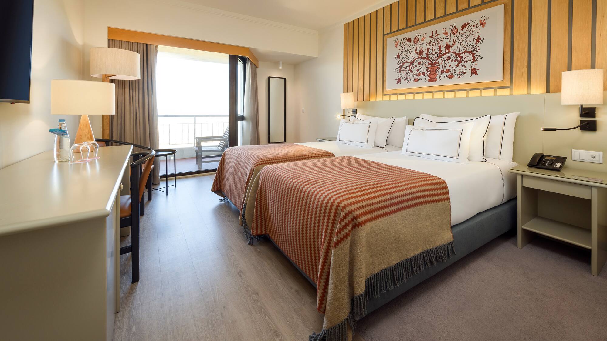 a room with two beds and a desk