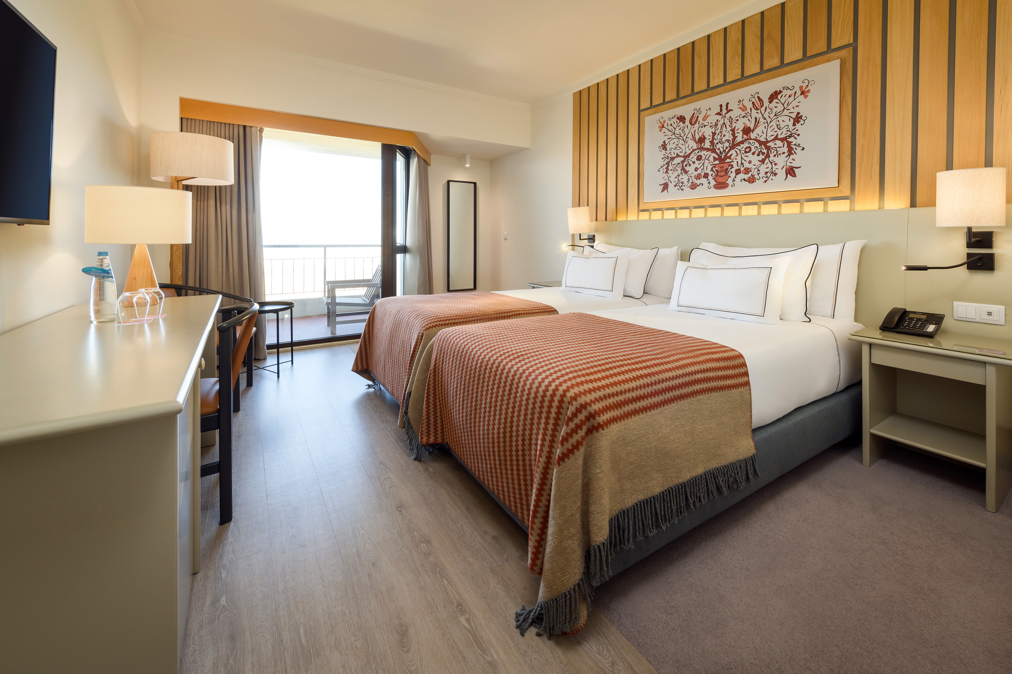 a room with two beds and a desk